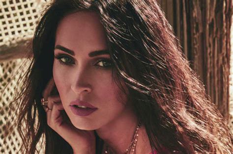 Megan Fox stunned at the 2022 GQ Men of the Year Party alongside her fiancé Machine Gun Kelly wearing one of her favorite styles, a naked, sparkly black sheer dress. See the photos.
